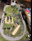 N-SCALE MODEL TRAIN LAYOUT, INCLUDES TRAINS