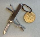 Vintage steel pocket knife with Anheuser Busch medallion keychain, ingredients