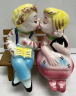vintage boy and girl kissing on bench salt and pepper shakers