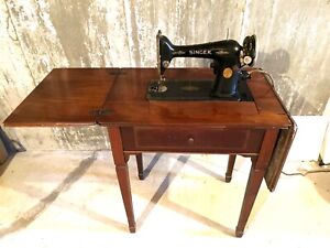 Vintage Singer sewing machine in cabinet