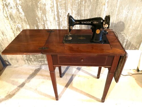 Vintage Singer sewing machine in cabinet