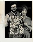 New Listing1987 Press Photo Artists Tom Mountjoy & Kathy Izard hold poster for Pi Kappa Phi