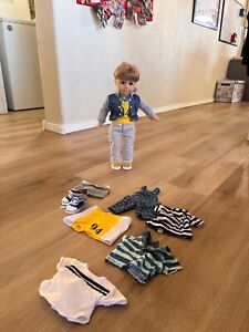 american girl doll logan with extra clothes- slightly used great condition
