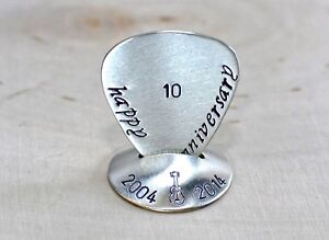 Anniversary sterling silver guitar pick and stand for a rocking celebration
