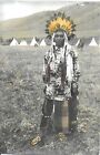 Tinted Color Photo of a Native American in Full Native Garb, Teepees in Back