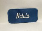 NELIDA USED EMBROIDERED VINTAGE SEW ON NAME PATCH TAGS WHITE ON PLAD BLUE