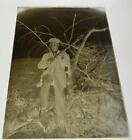 Antique glass plate photo negative Man with Gun standing on a tree early 1900's