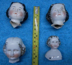 4 old painted china doll heads , damage ,