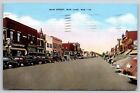 Main Street~Rice Lake Wisconsin~Storefronts & Parked Vehicles~PM 1943~Postcard