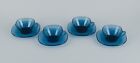 Vereco, France, a set of four teacups and matching saucers in blue glass.