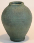 Diminutive Merrimac cabinet vase, finely ribbed with a dry matte green glaze.