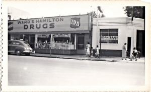 1950s Photograph Of People Walking On Sidewalk By Ward & Hamilton IDA Store