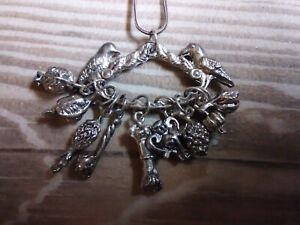 Silver tone multi charm necklace - birds - grapes ? - hand ?