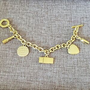 Estee Lauder Gold Tone Charm Toggle Bracelet 8