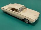 Up for auction is a tan 1961 Ford Thunderbird promo car.