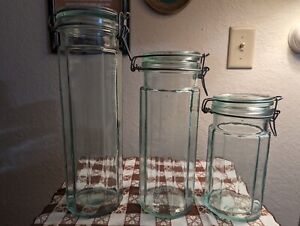 A Set Of Three Vintage Hermetic Green Tint Glass Jars