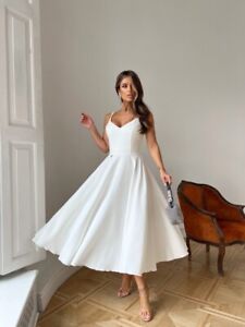 Cocktail dress with thin straps of milky color