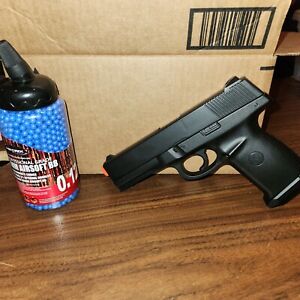 Airsoft glock pistol and container of airsoft bbs, spring loaded, tested & works