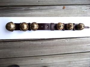 6 ANTIQUE SLEIGH BELLS ON A LEATHER STRAP
