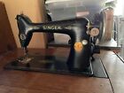 vintage singer sewing machine in cabinet with attachments
