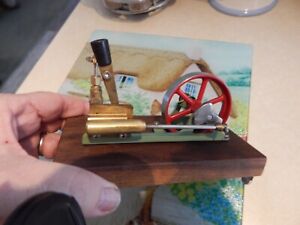 small live steam engine model on wood base