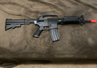 spring powered airsoft gun m16 with battery powered uv light (needs batteries)