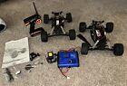 Two Vintage Duratrax Evader Trucks w/Remote, Charger,Parts Lot