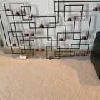 crate and barrel brown metal wall art with votives and candles. 49